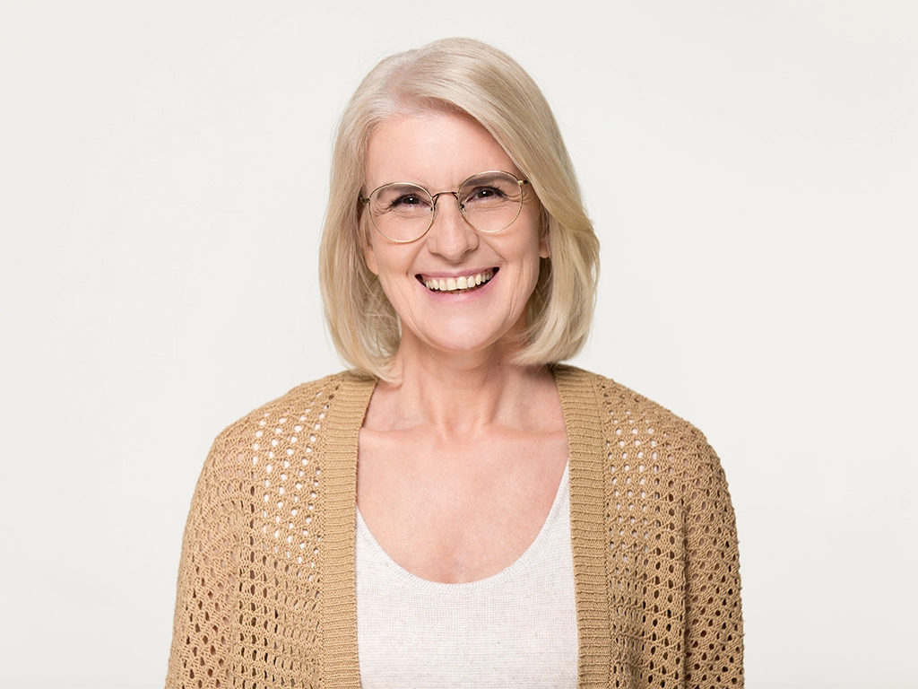 happy older woman in glasses isolated on background