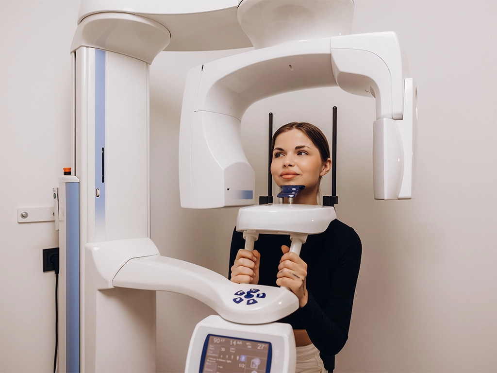 woman undergoing dental panoramic x-ray examination