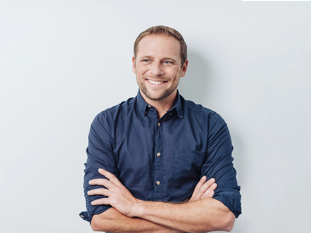 young man with a thoughtful pleased smile